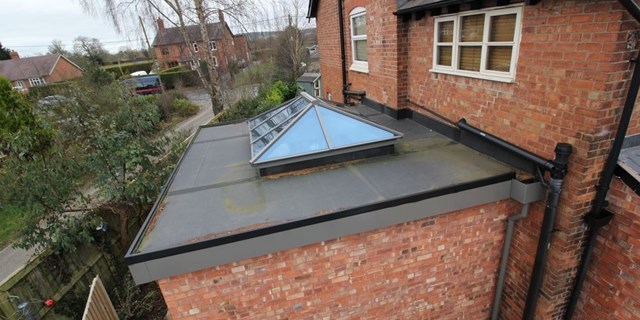 Aerial shot of orangery roof detail showing aluminium 44mm triple glazed roof lantern supplied in specified RAL colour by John Knight Glass and Firestone roof supplied and fitted by OPB Wirral builders.