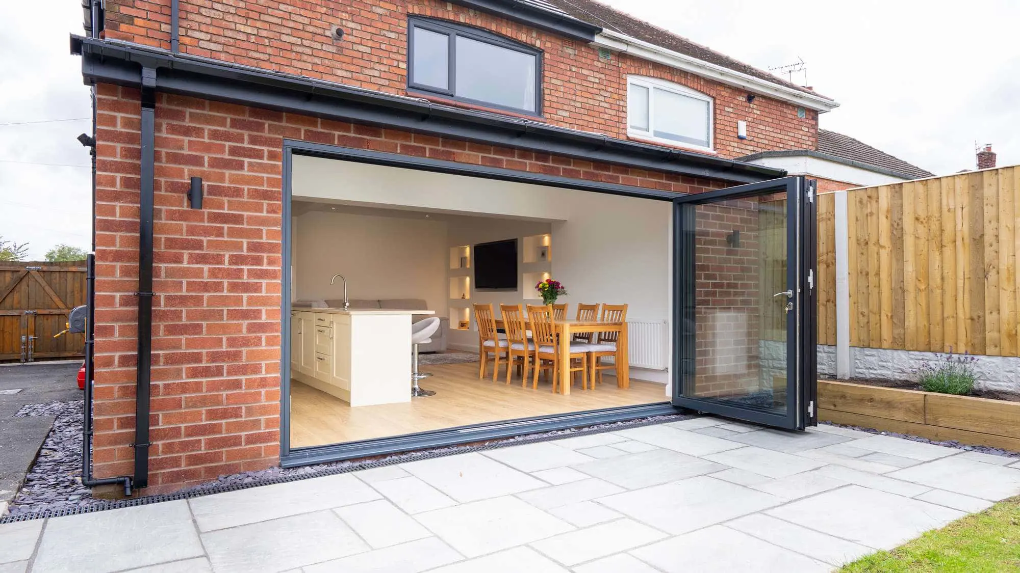 External view of new kitchen extension with black fascia's and bi-folding doors.